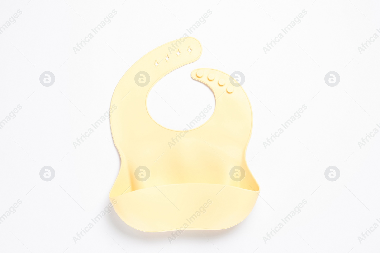 Photo of Beige silicone baby bib isolated on white, top view