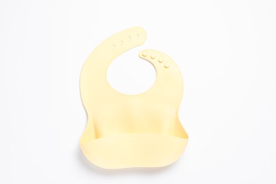 Photo of Beige silicone baby bib isolated on white, top view