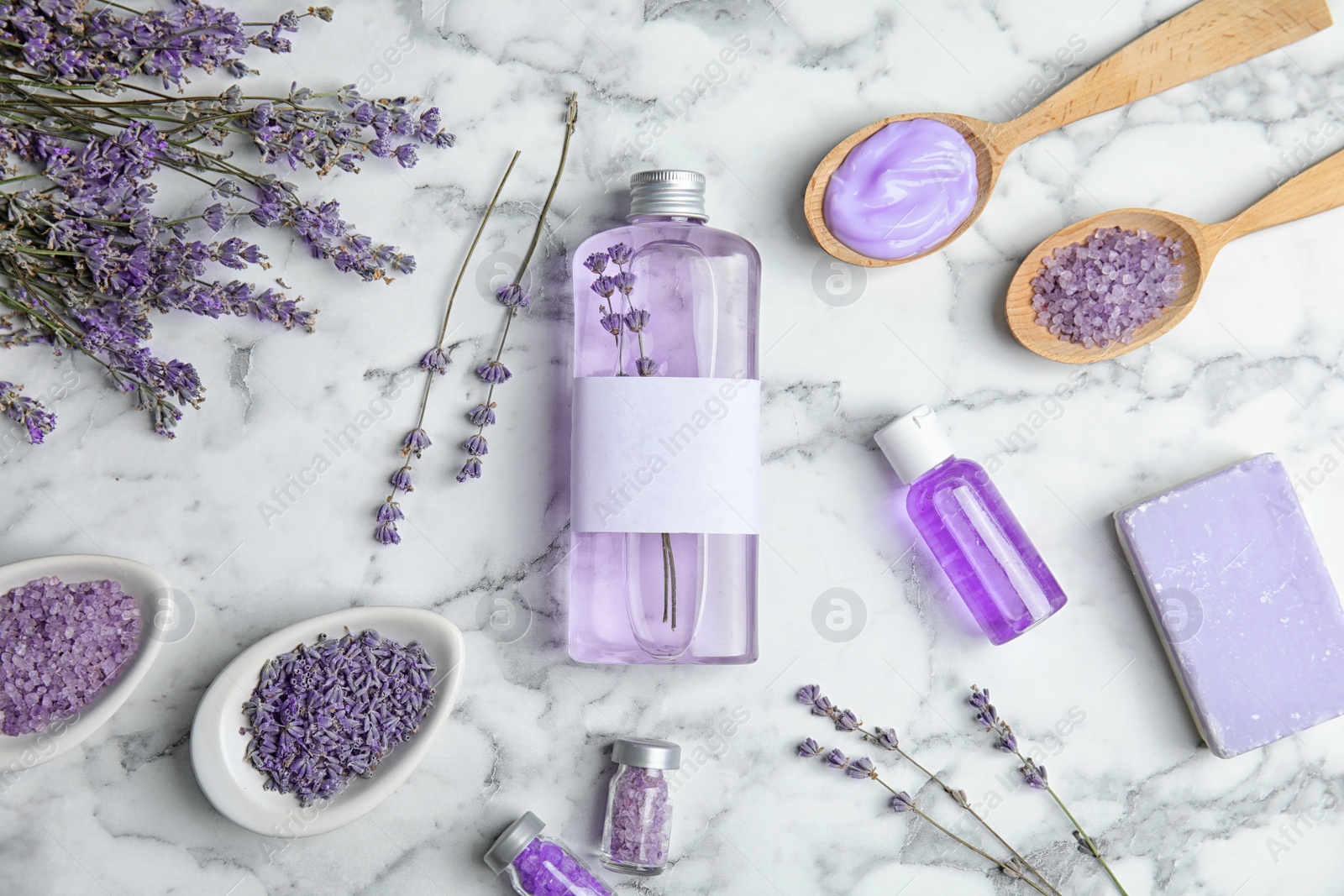 Photo of Flat lay composition with lavender flowers and natural cosmetic products on marble background