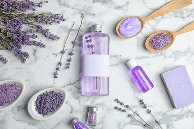 Flat lay composition with lavender flowers and natural cosmetic products on marble background