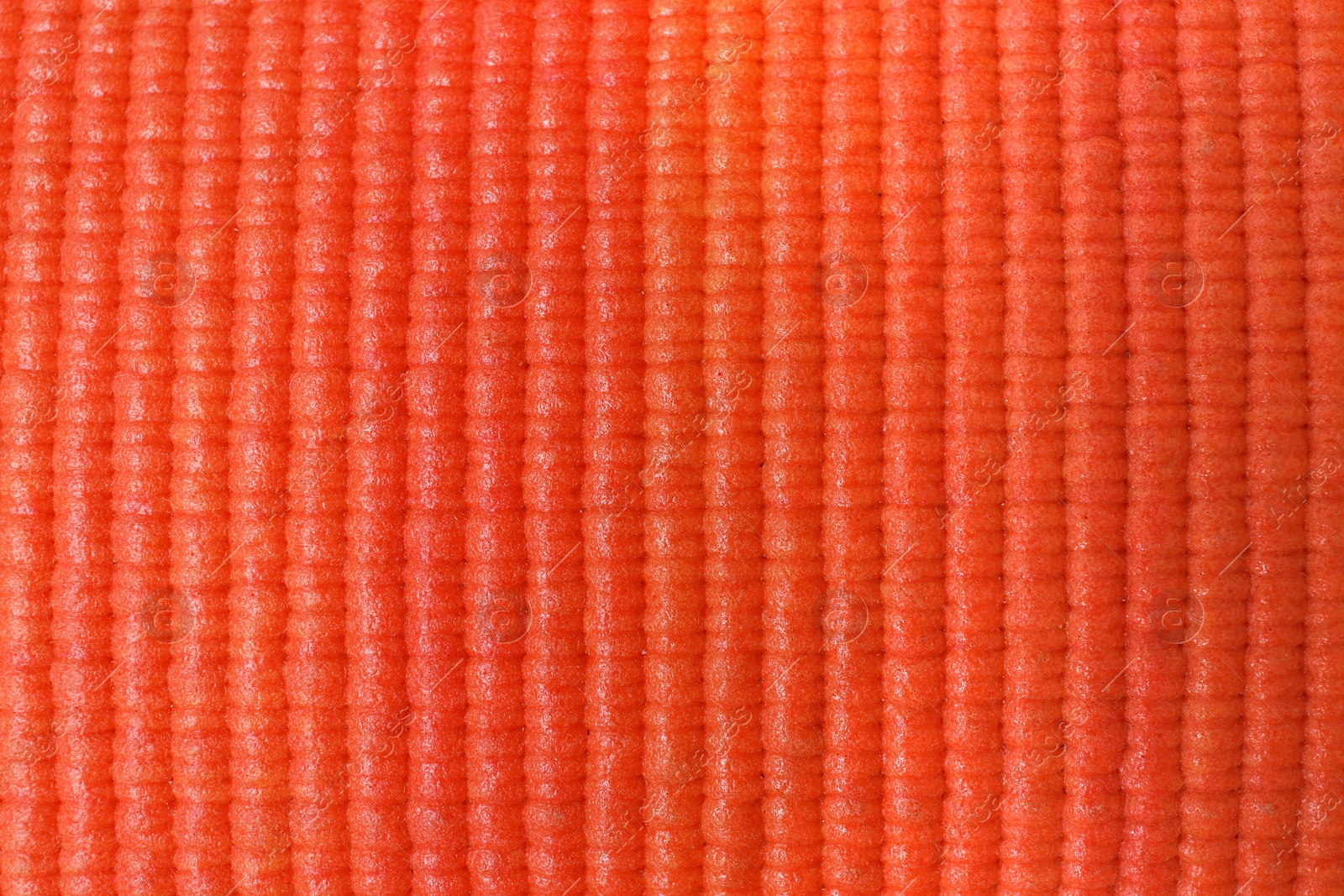 Photo of Orange foam rubber mat as background, top view