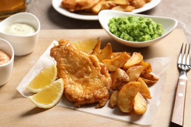 British traditional fish and potato chips on wooden board