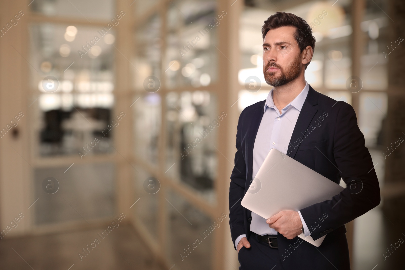 Image of Successful lawyer with laptop on blurred background, space for text