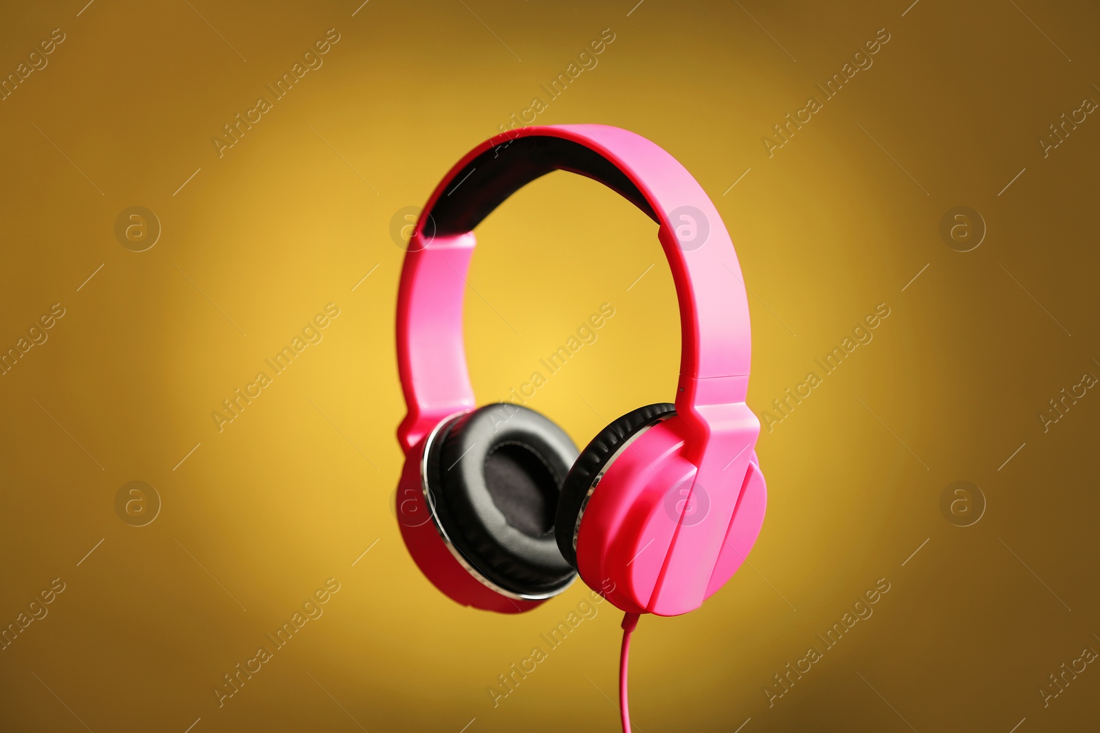 Photo of Stylish headphones with pads on color background