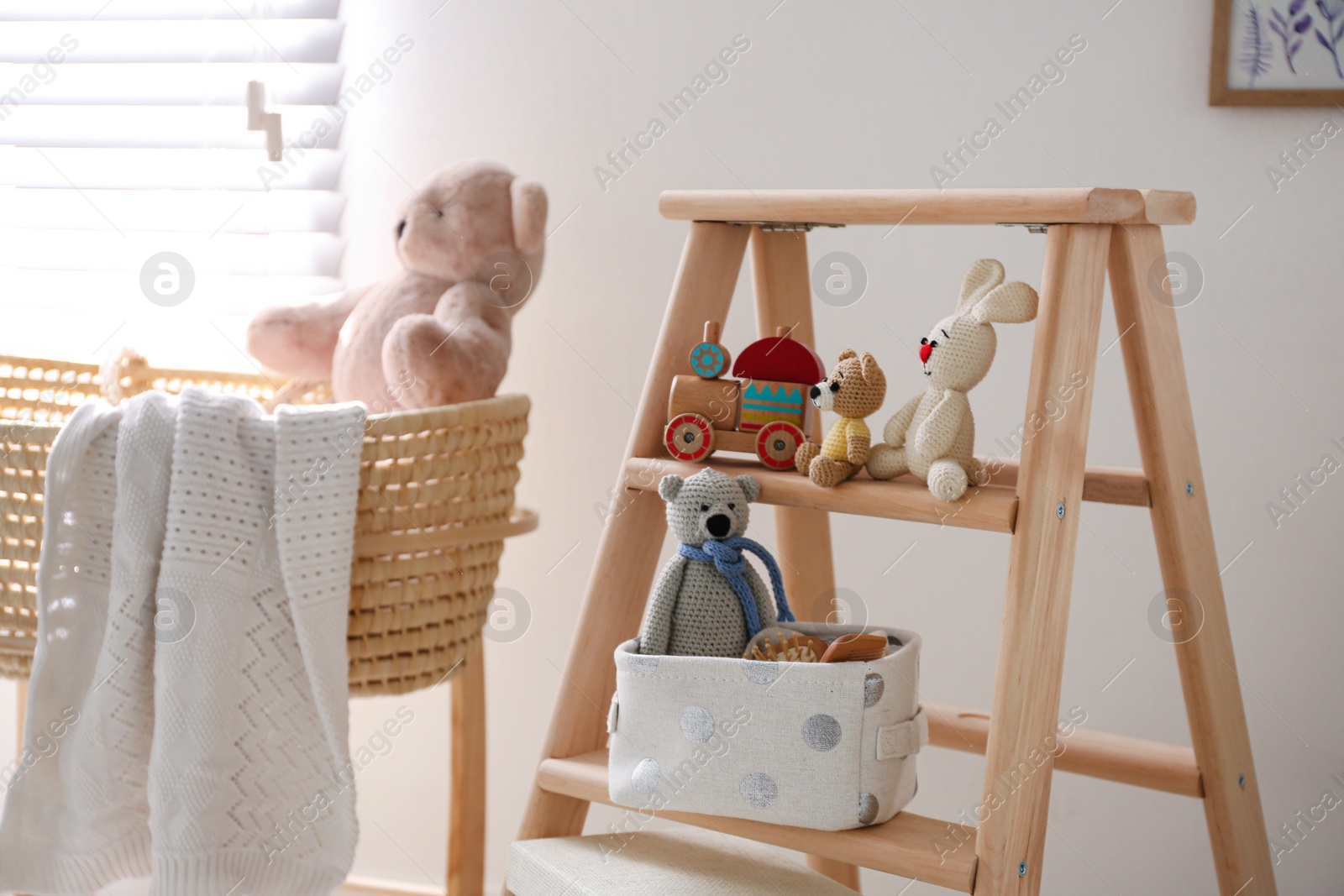 Photo of Decorative ladder with toys and different stuff in stylish baby room. Idea for interior design