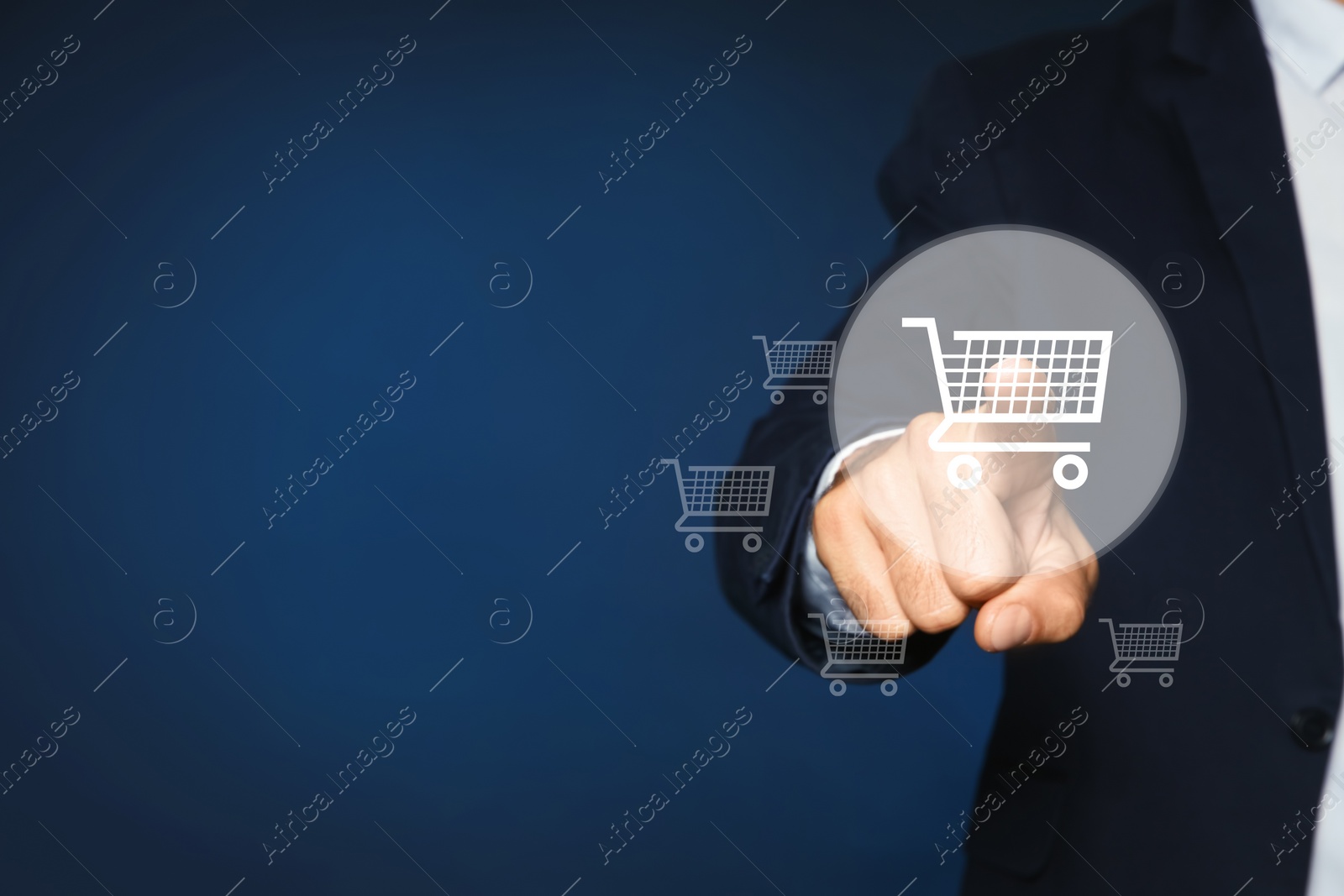 Image of Man demonstrating virtual image of shopping cart on dark blue background, closeup. Space for text