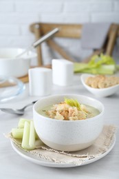 Photo of Bowl of delicious celery soup on white table