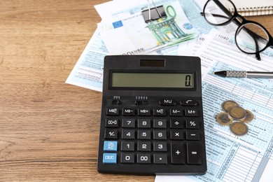 Tax accounting. Calculator, documents, money, glasses and pen on wooden table, closeup. Space for text