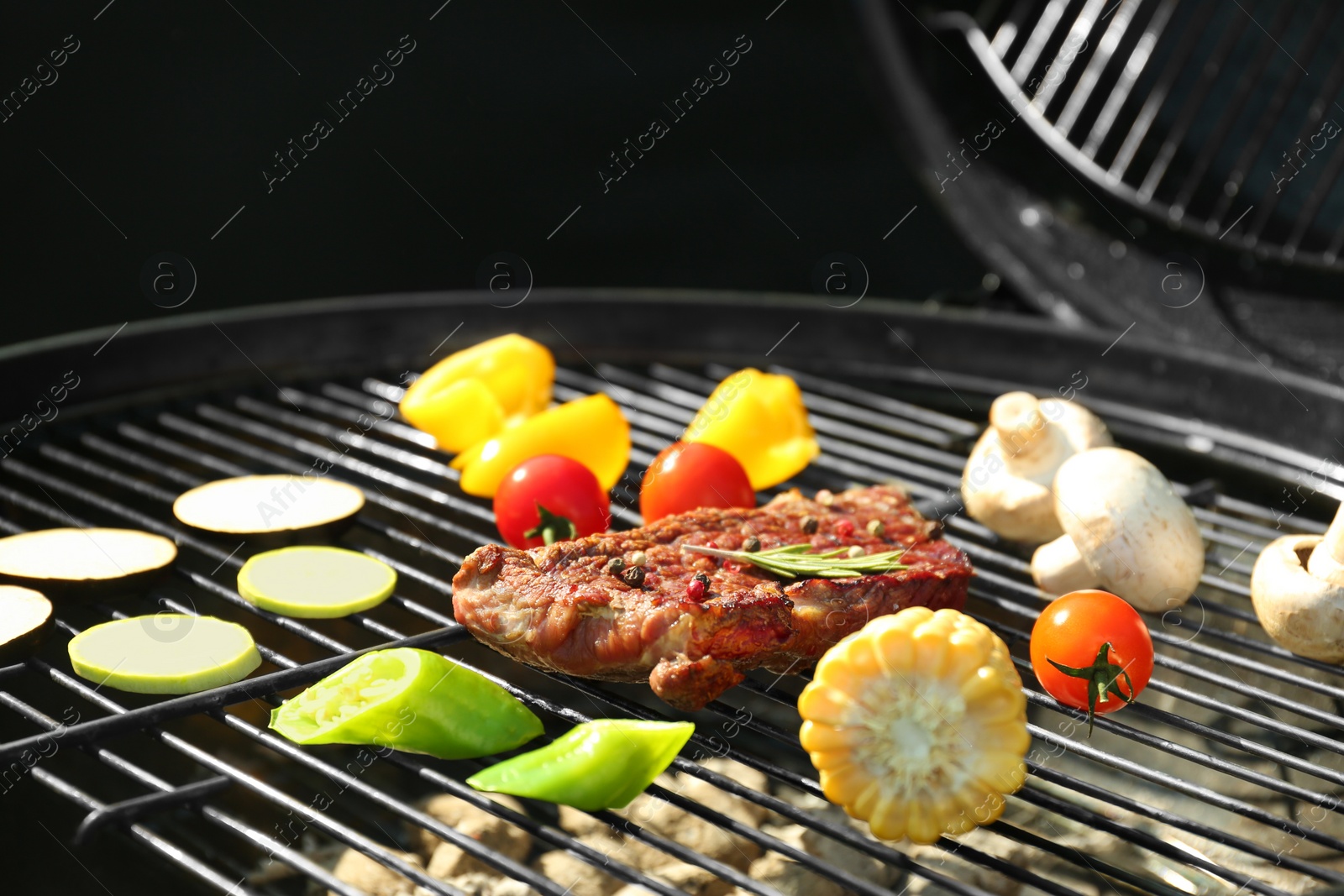 Photo of Tasty steak and vegetables on modern barbecue grill, closeup