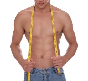 Photo of Shirtless man with slim body and measuring tape isolated on white, closeup