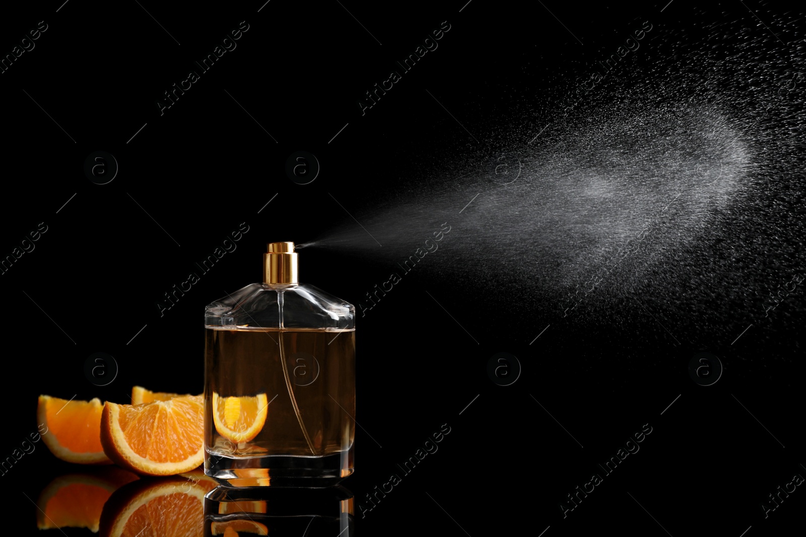 Photo of Spraying bottle of perfume and slices of citrus fruit on black background