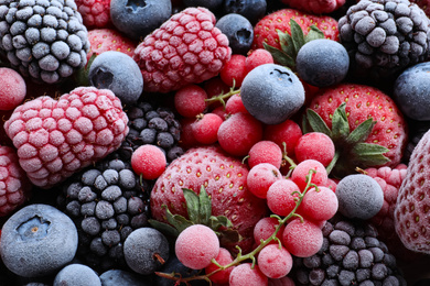 Photo of Mix of different frozen berries as background, top view