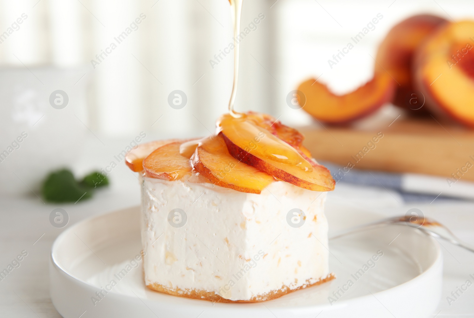 Photo of Delicious dessert with peach slices on plate, closeup