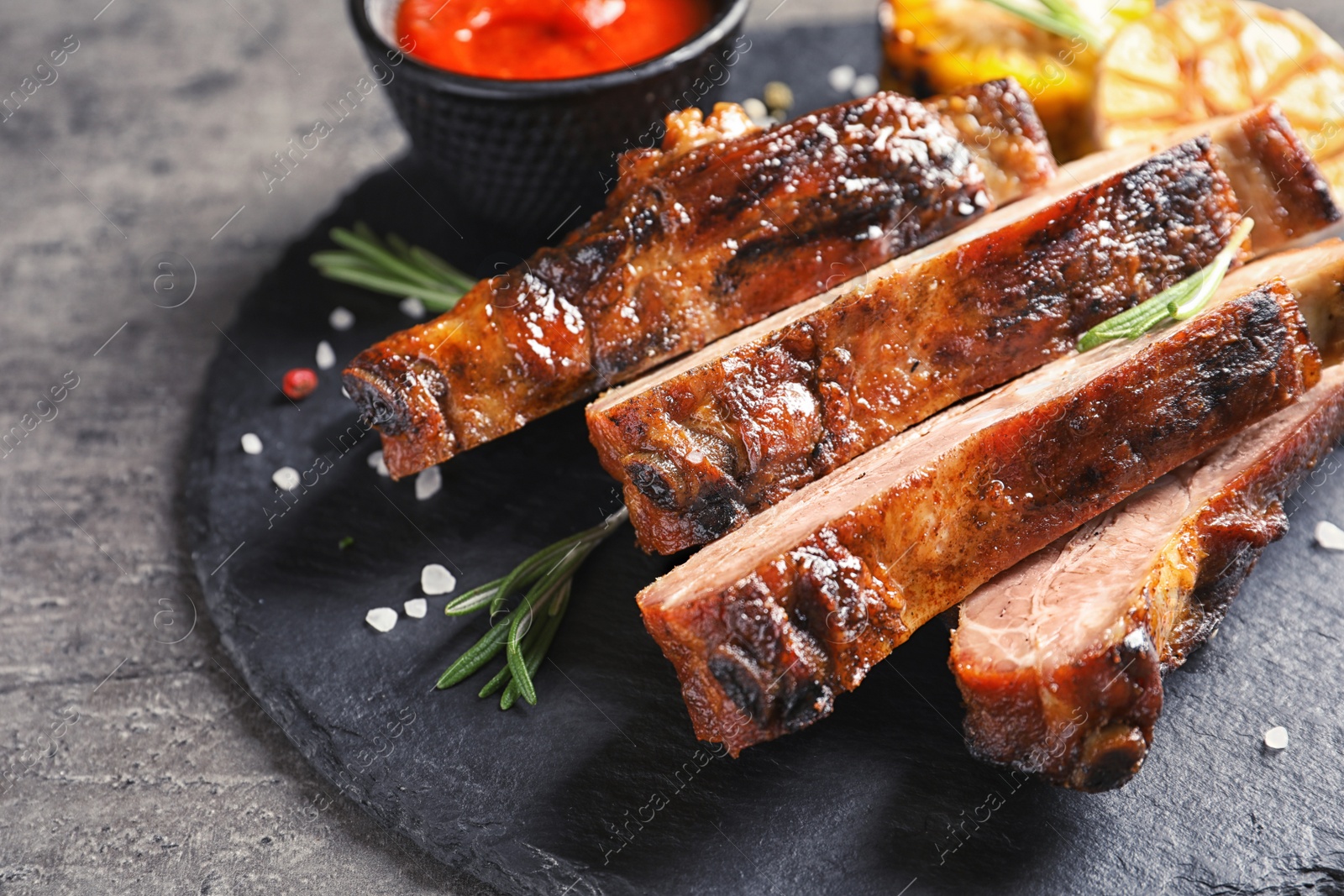 Photo of Delicious meat served for barbecue party on gray table