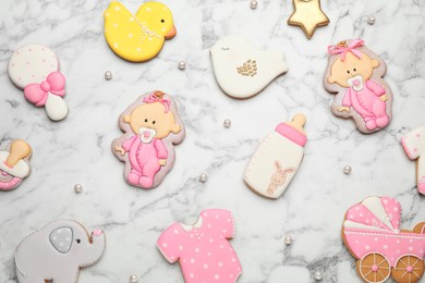 Photo of Set of baby shower cookies on white marble table, flat lay