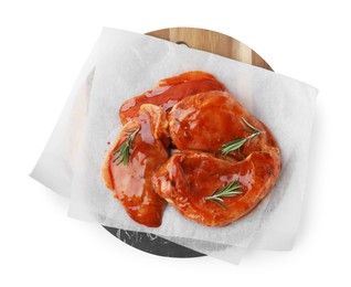Photo of Board with raw marinated meat and rosemary isolated on white, top view