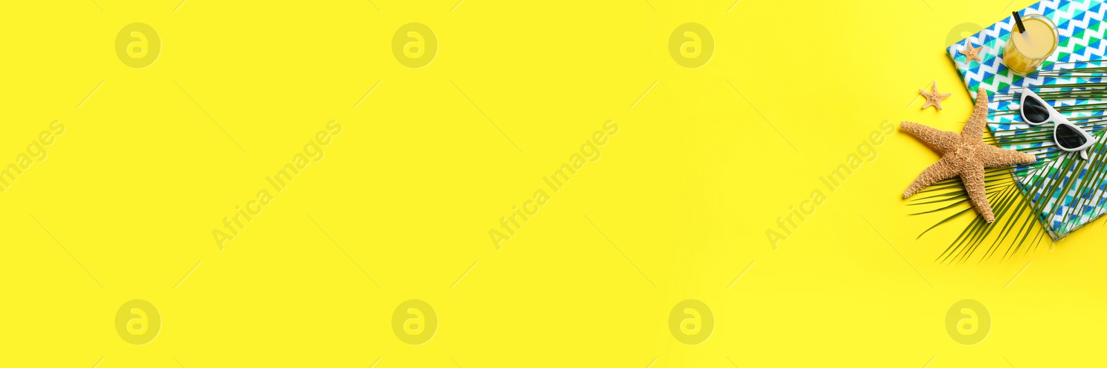 Photo of Beach accessories and space for text on yellow background, flat lay. Banner design