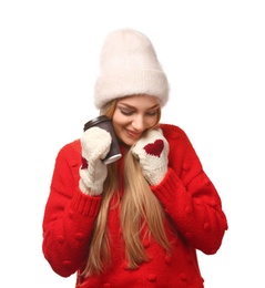 Portrait of young woman in stylish hat and sweater with paper coffee cup on white background. Winter atmosphere