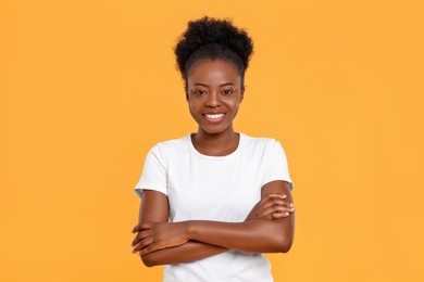 Photo of Portrait of happy young woman on orange background