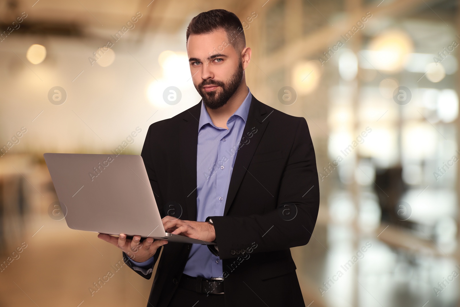 Image of Successful lawyer with laptop on blurred background