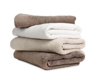 Photo of Folded soft terry towels on white background