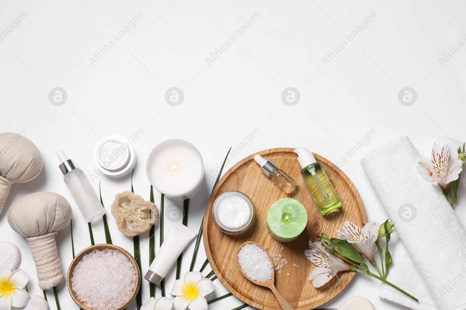 Photo of Flat lay composition with spa essentials on white background. Space for text