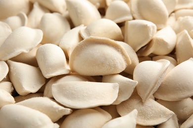 Photo of Raw dumplings as background, closeup. Home cooking