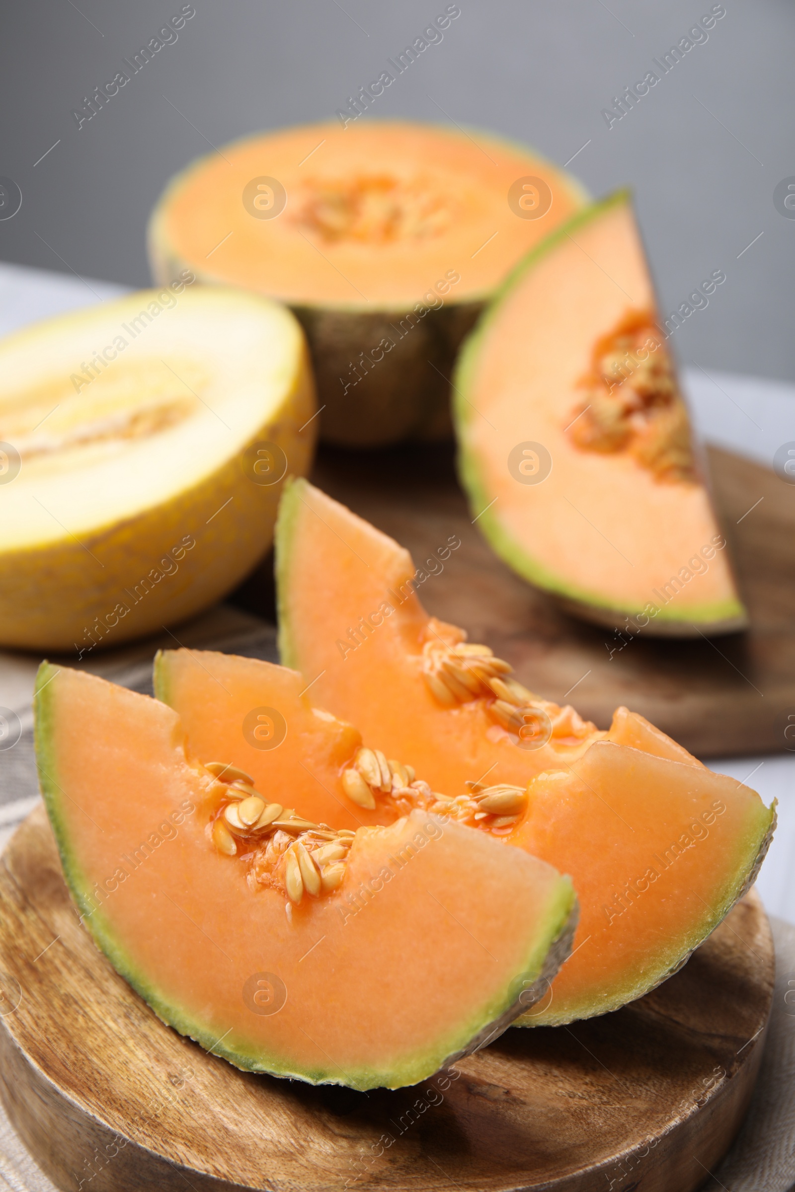 Photo of Tasty colorful ripe melons on table, closeup