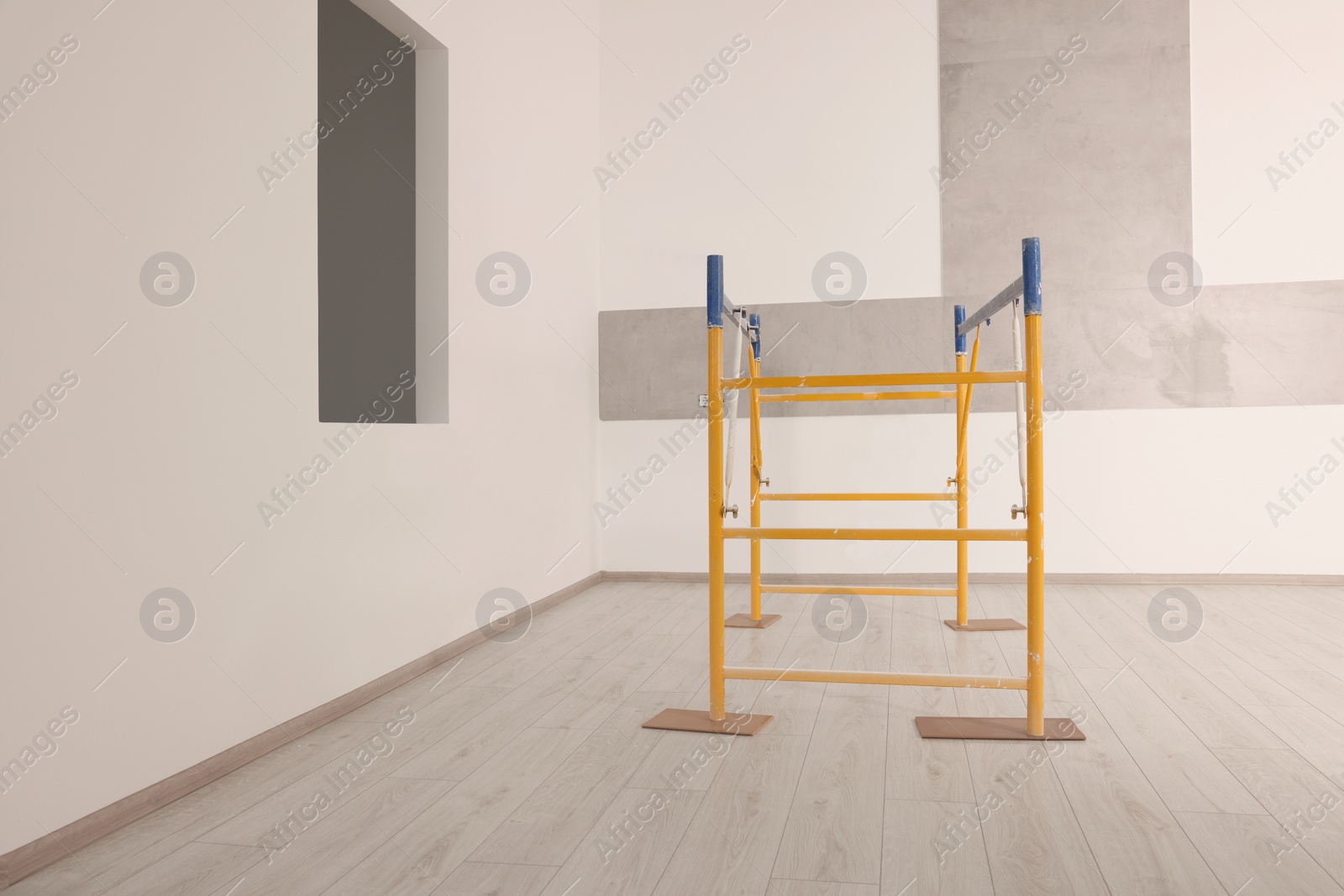 Photo of Professional construction scaffold in empty renovated room