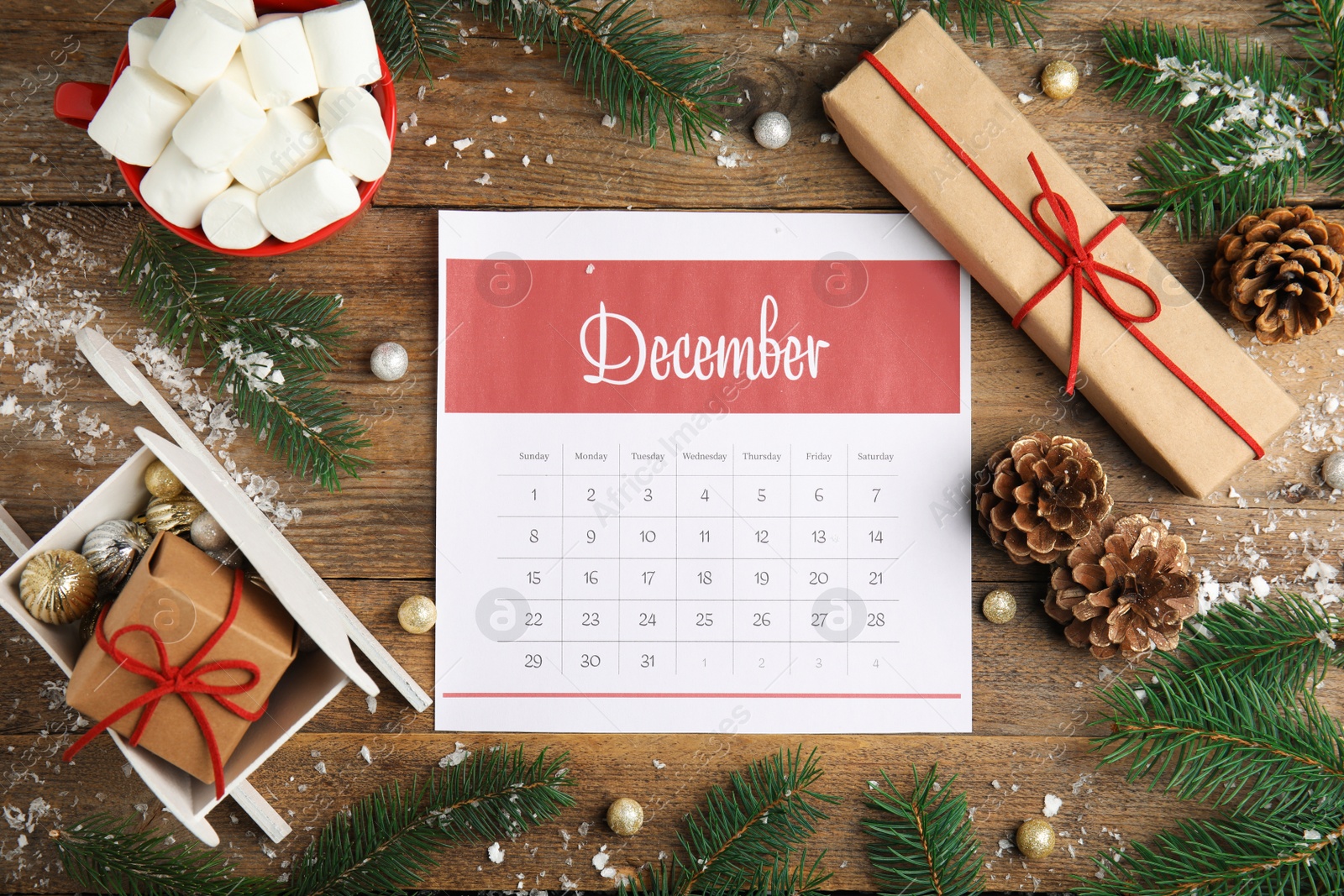 Photo of Flat lay composition with paper calendar on wooden table