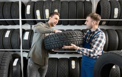 Photo of Service center consultant helping customer to choose tire in store