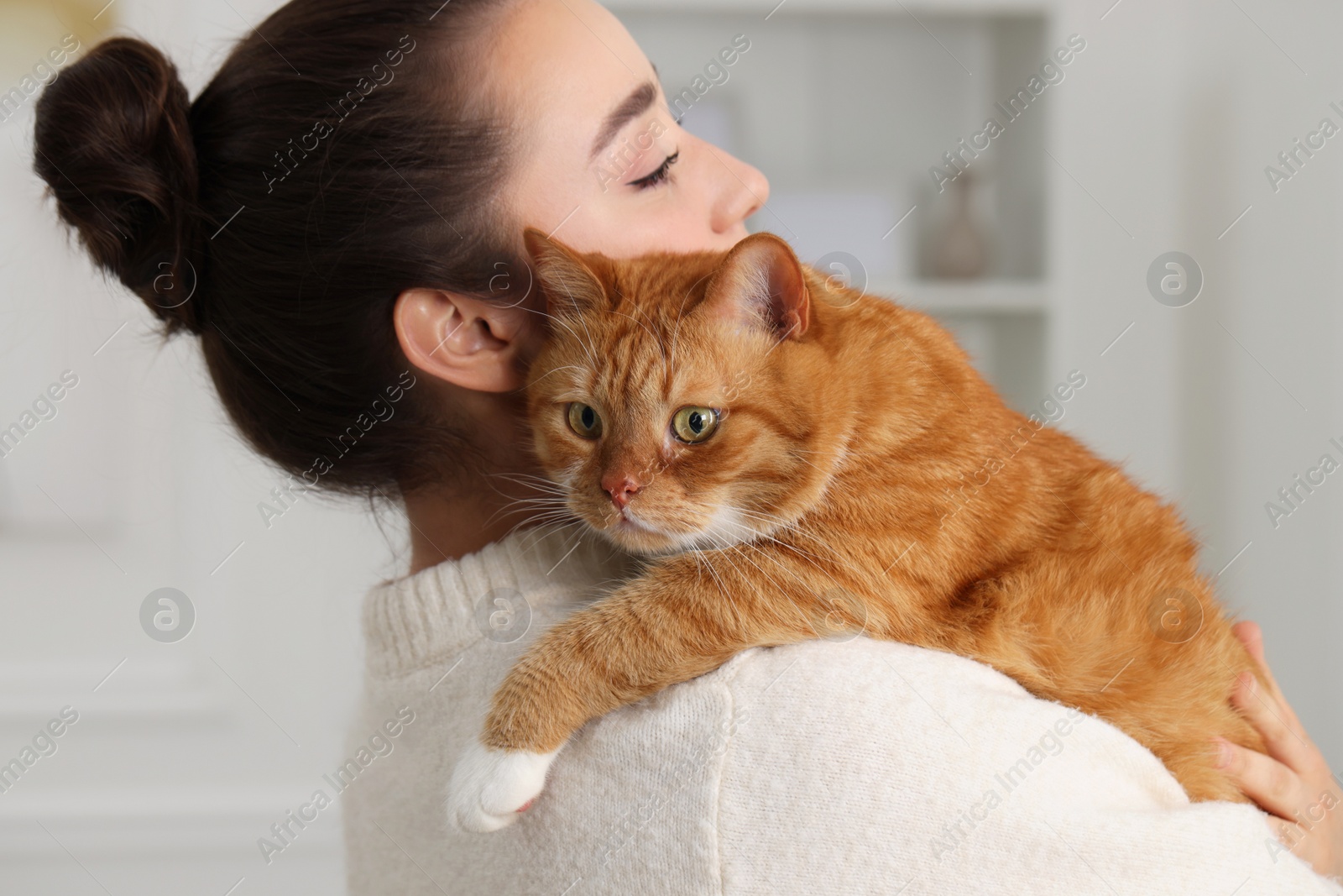 Photo of Beautiful woman with cute cat at home