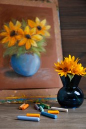 Yellow flowers, beautiful drawing and set of colorful pastels on wooden table