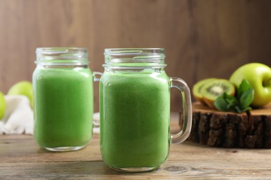 Photo of Tasty fresh green smoothie on wooden table