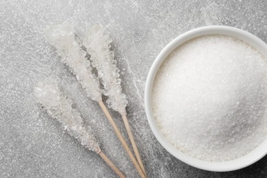 Photo of Different types of sugar on light grey table, flat lay