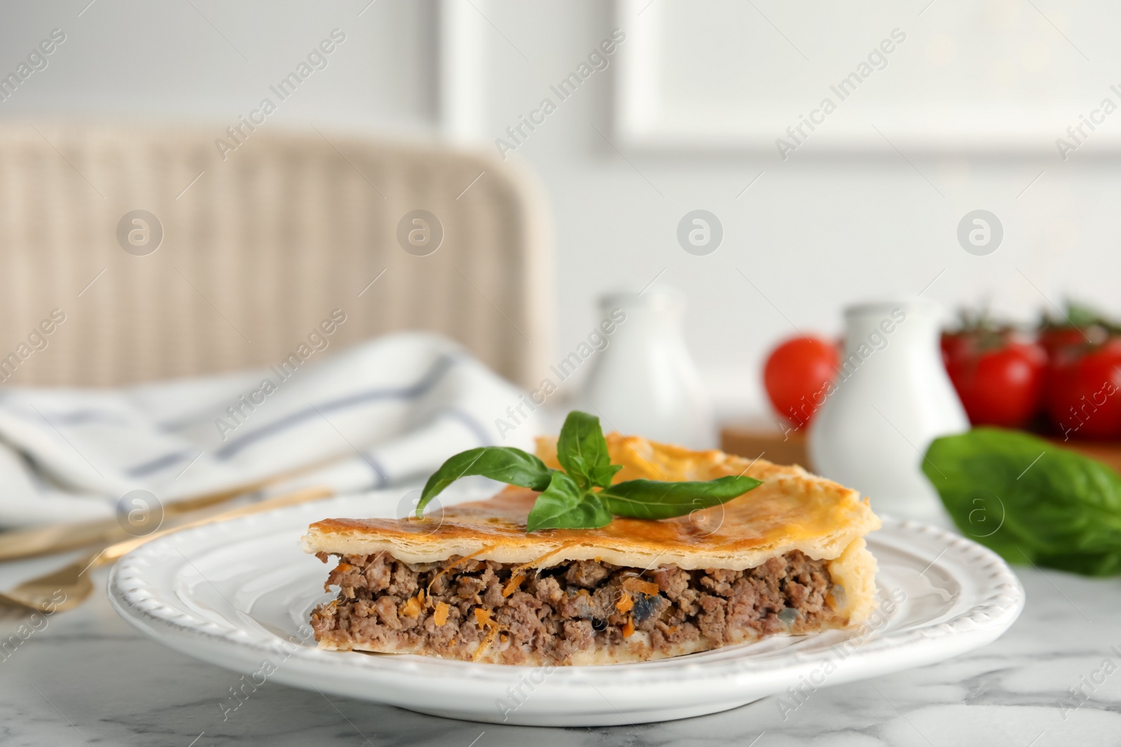 Photo of Piece of delicious pie with minced meat on table indoors