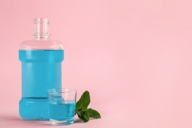 Photo of Mouthwash and fresh mint on pink background, space for text