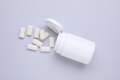 Photo of Jar with chewing gums on light grey background, flat lay