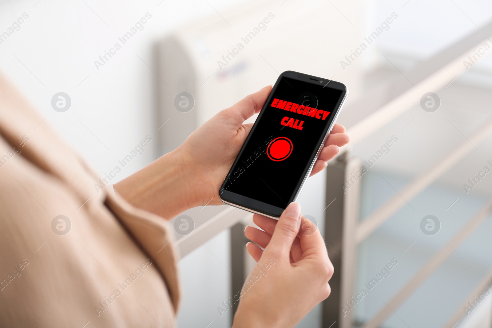 Image of Hotline service. Woman making emergency call via smartphone indoors, closeup