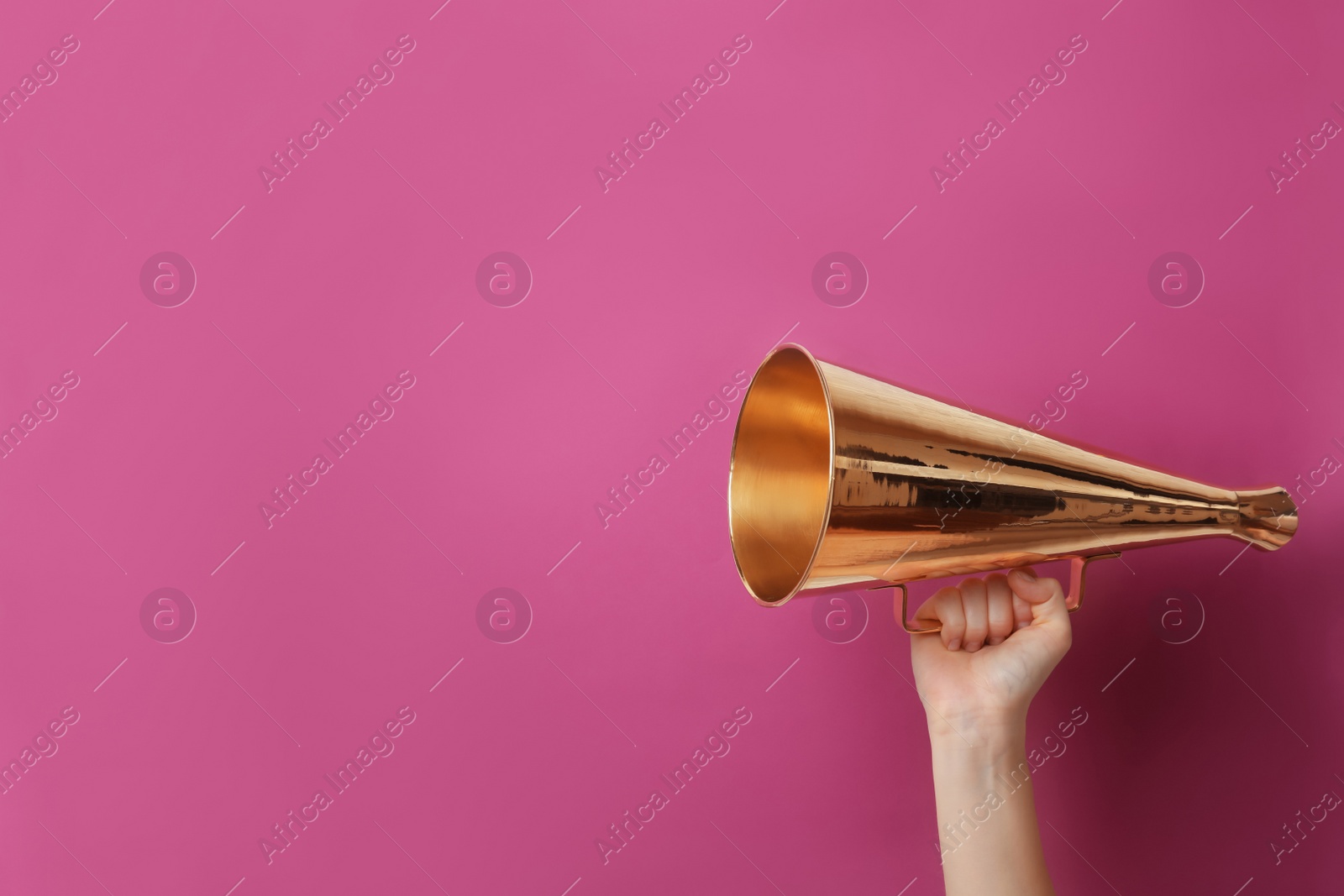 Photo of Woman holding retro megaphone on color background