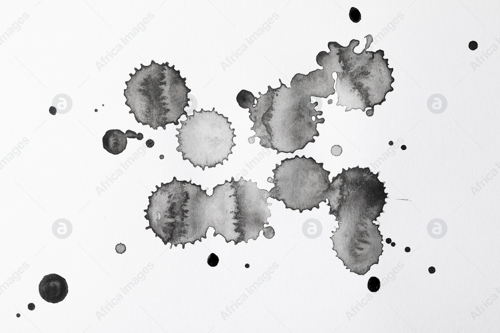 Photo of Blots of black ink on white background, flat lay