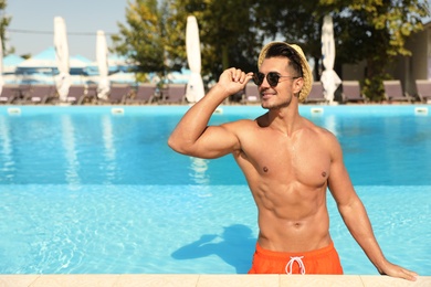 Young man in pool on sunny day