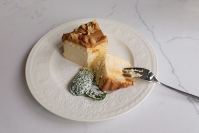 Tasty dessert and fork on white marble table