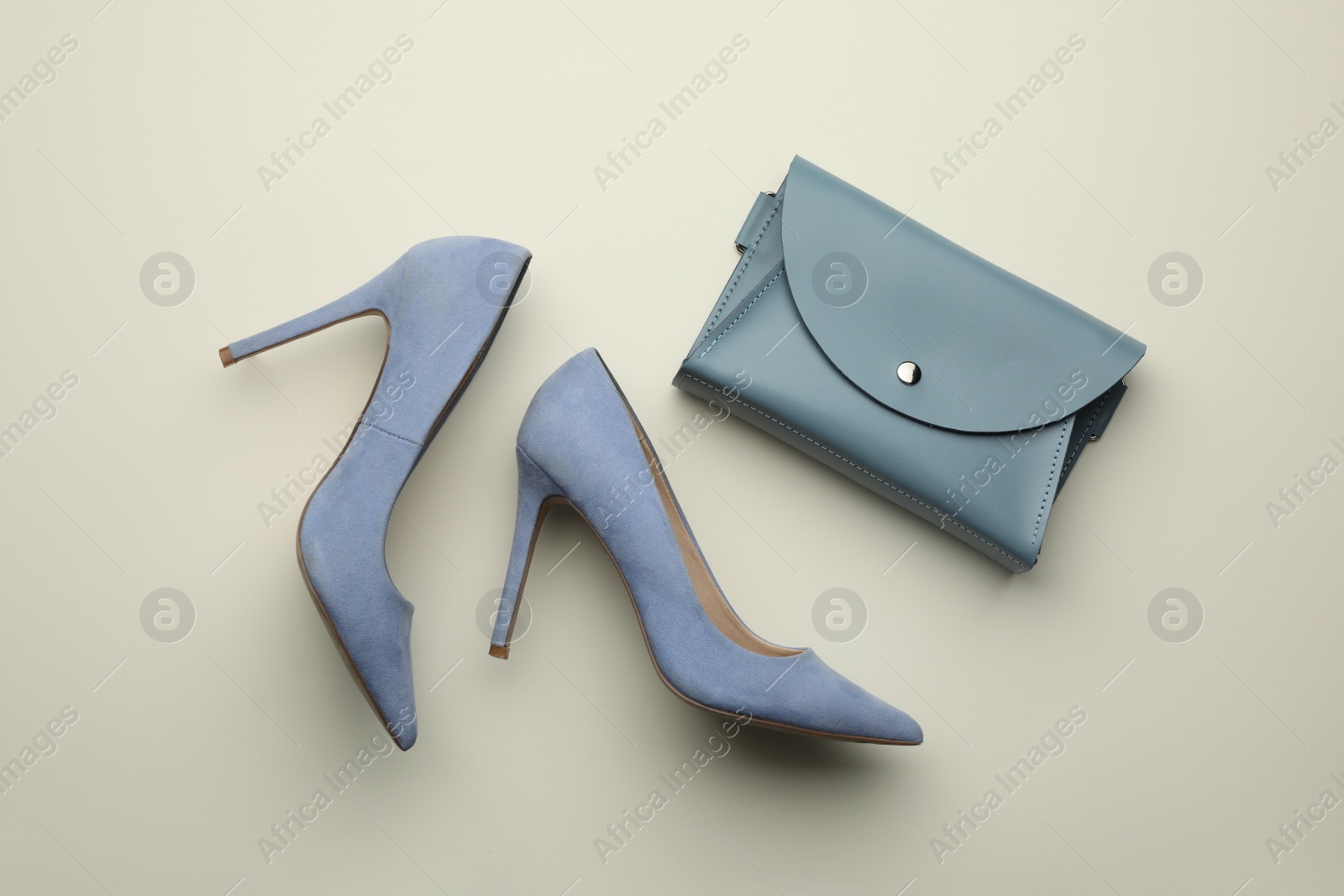 Photo of Stylish woman's bag and shoes on light background, flat lay