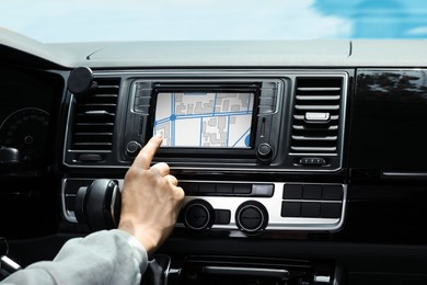 Image of Man using navigation system while driving car, closeup