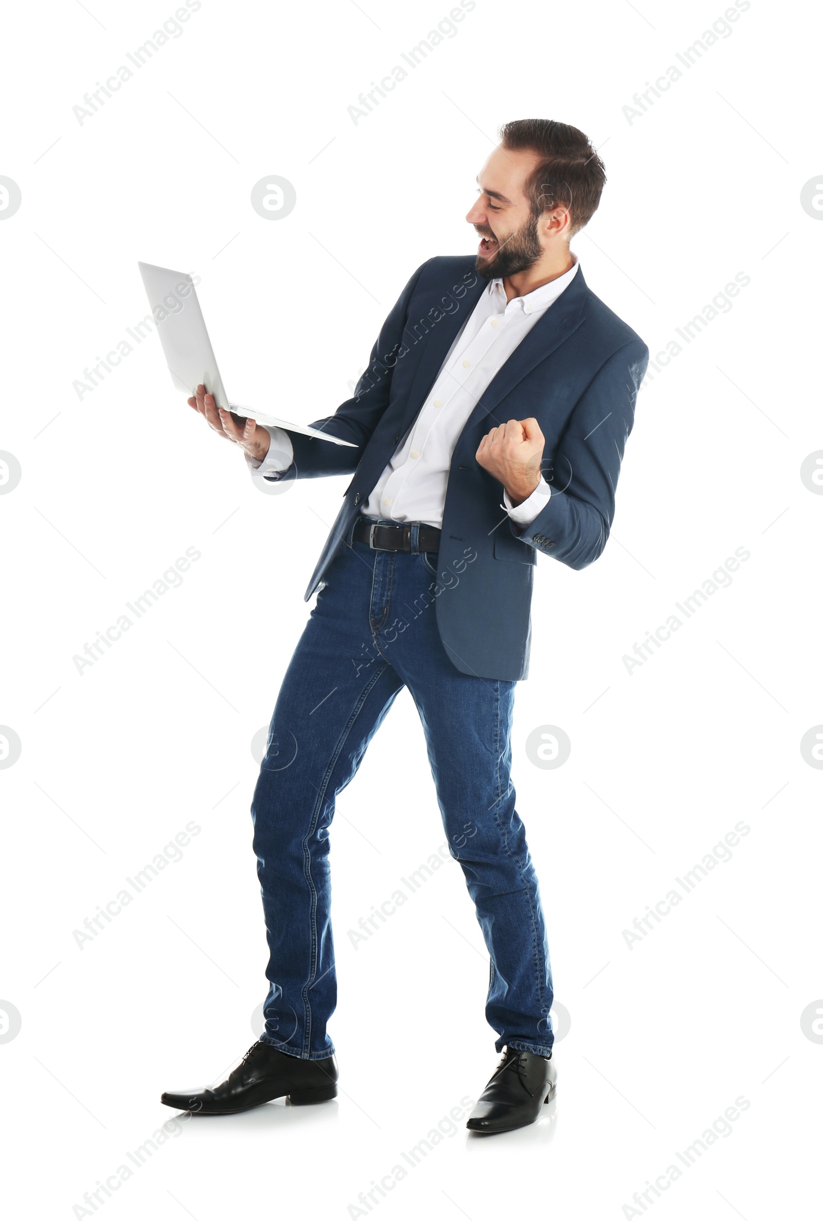 Photo of Emotional businessman in office wear with laptop celebrating victory on white background