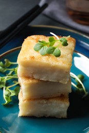 Photo of Delicious turnip cake with microgreens served on plate, closeup