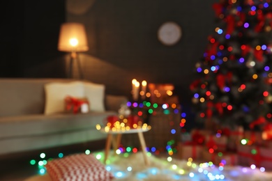 Photo of Blurred view of stylish room interior with decorated Christmas tree