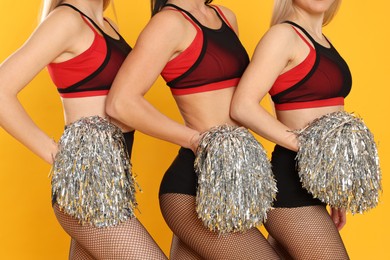 Photo of Group of cheerleaders on yellow background, closeup