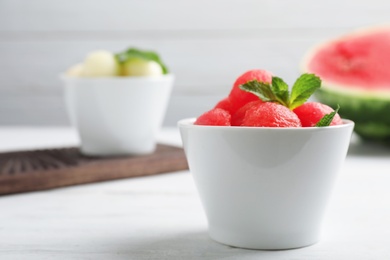 Bowl with tasty watermelon balls on table